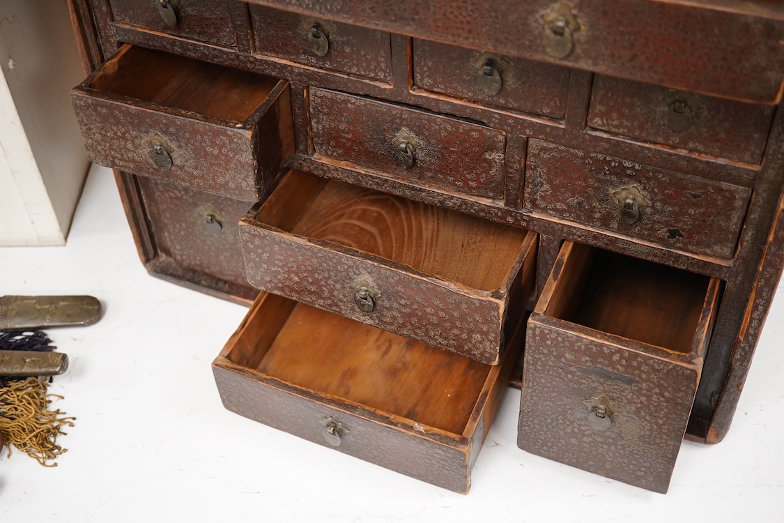 An 18th century Chinese lacquered table top cabinet, 52cm wide